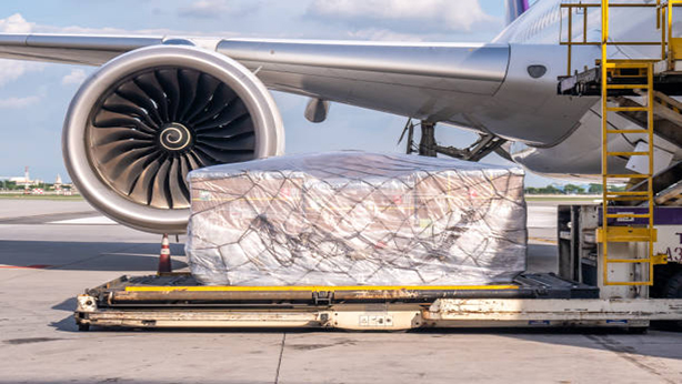 Air cargo logistic containers are loading to an airplane. Air transport shipment prepare for loading to modern freighter jet aircraft at the airport.